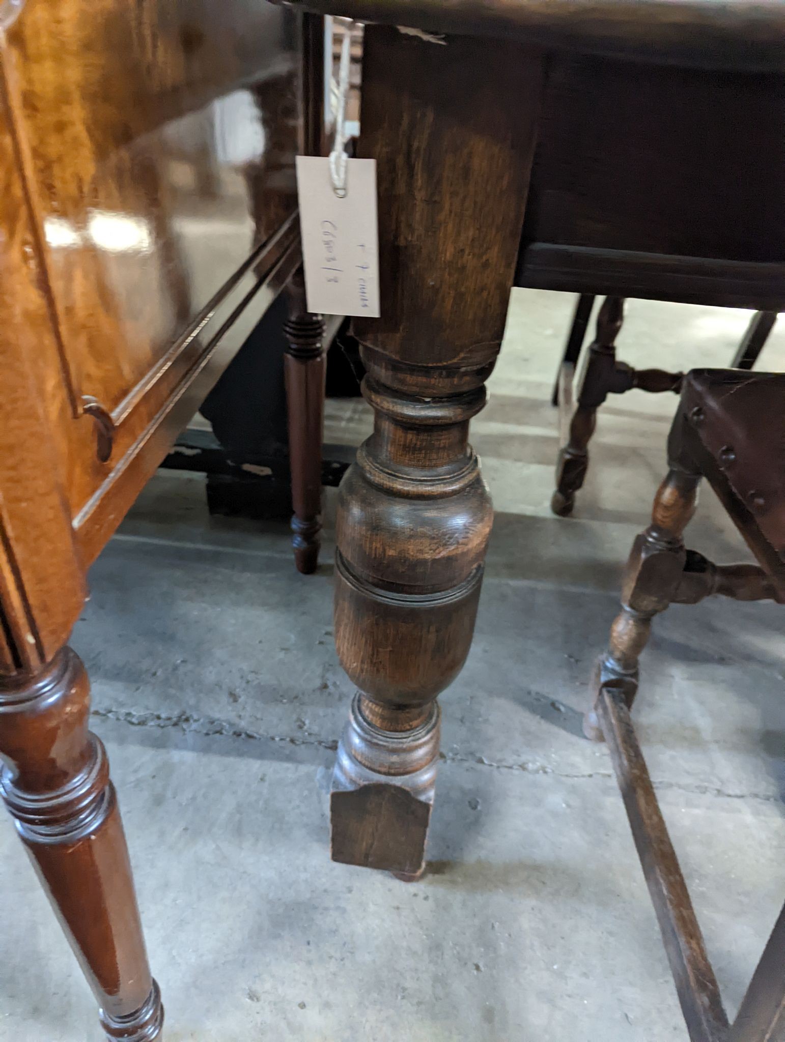 A 1920's oak extending dining table, 238cm extended (two spare leaves), width 120cm, height 74cm together with seven oak dining chairs (one with arms)